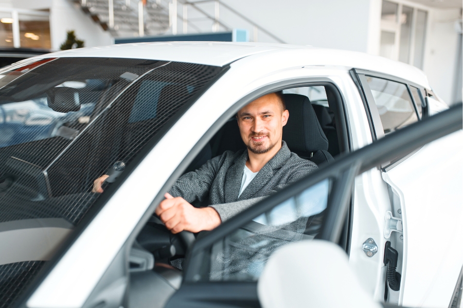 Man Driving a White Car