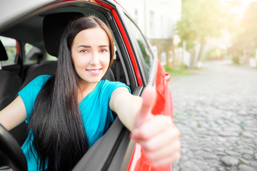 Woman Driving a Red Car