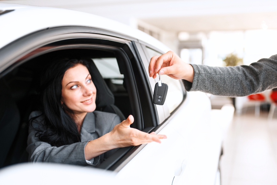 Woman Driving a White Car