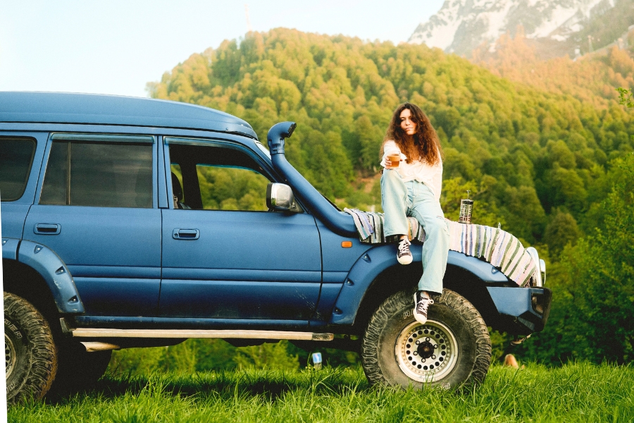 Woman Driving a Blue Car