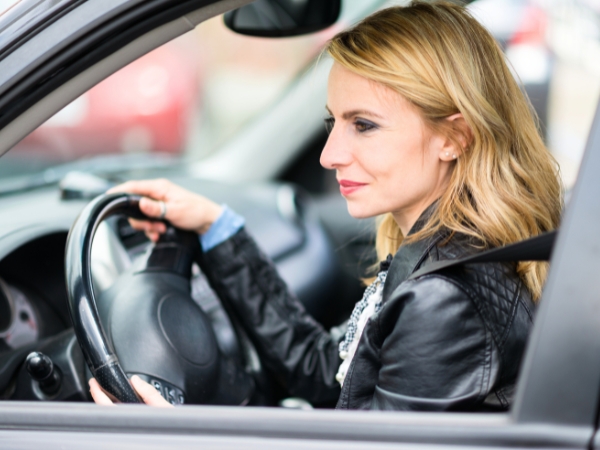 Woman Driving a Black Car